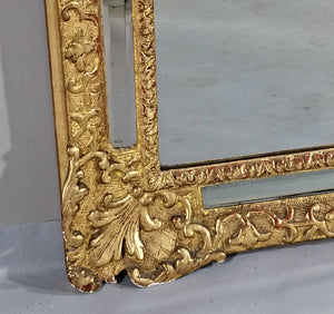 Miroir à parclose en bois doré sculpté de fleurs et écoinçons